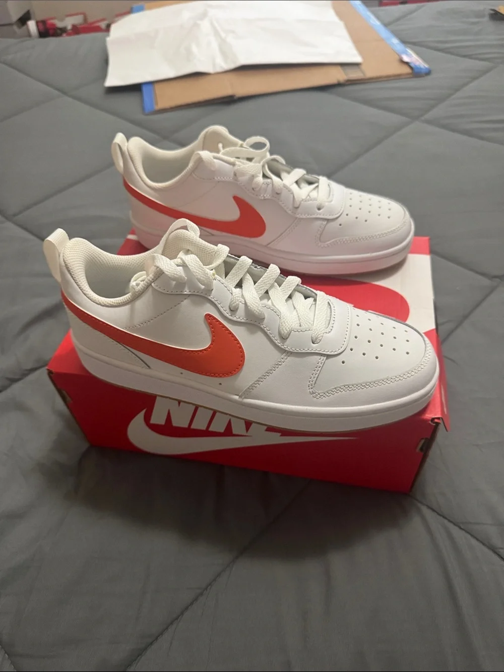 Nike Kids White Sneakers with Orange Swoosh Accent